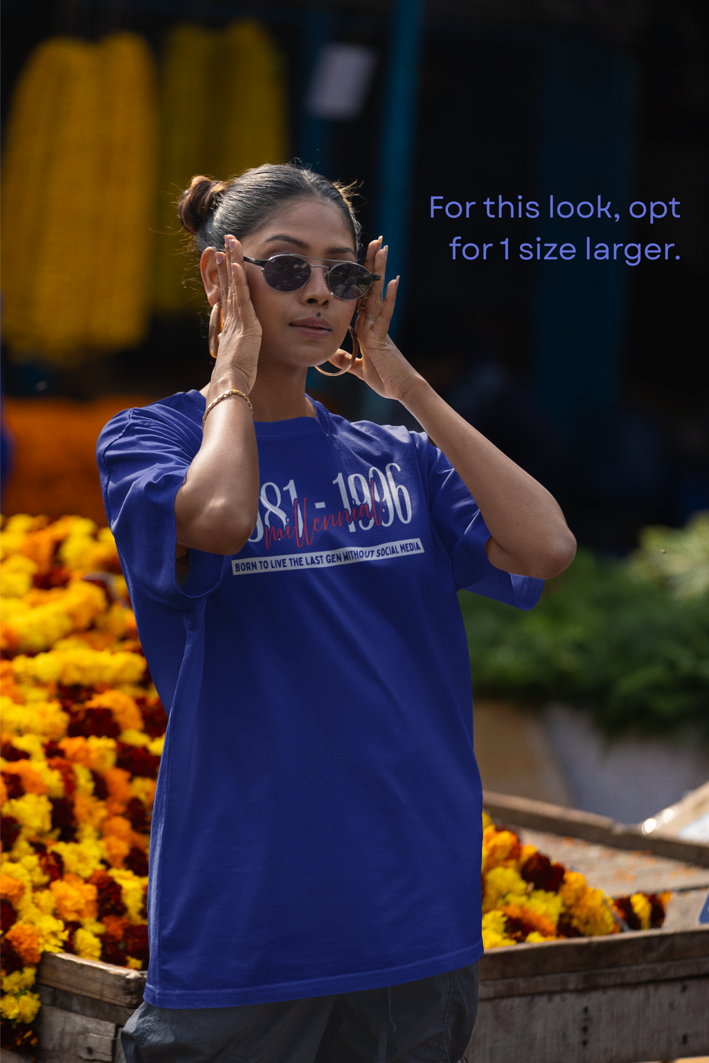 Woman wearing sunglasses in front of a market stall with flowers