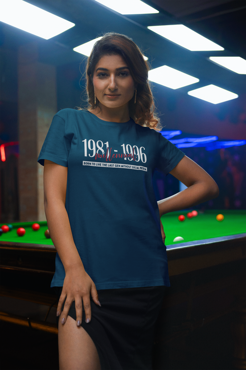 Woman wearing a blue t-shirt with text standing in front of a pool table.