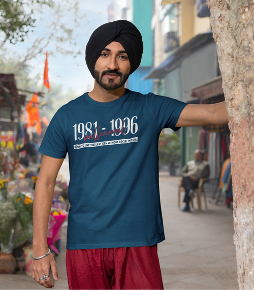 Man wearing a blue t-shirt with text, standing in an outdoor market setting.