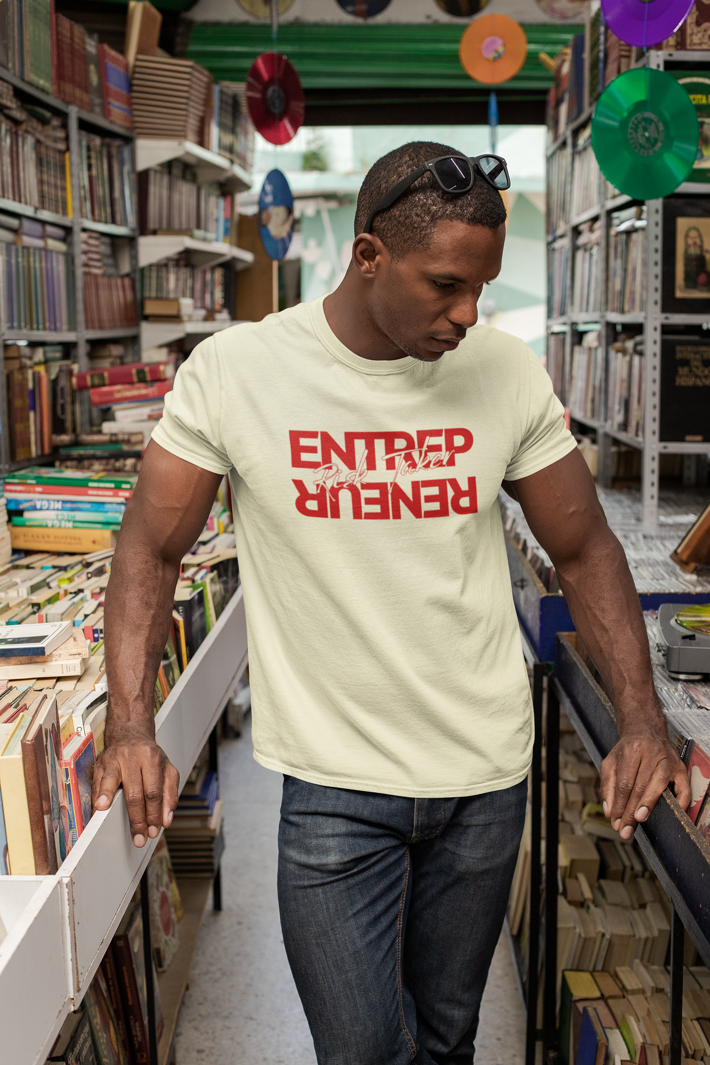Man wearing a 'ENTREPRENEUR' t-shirt in a bookstore