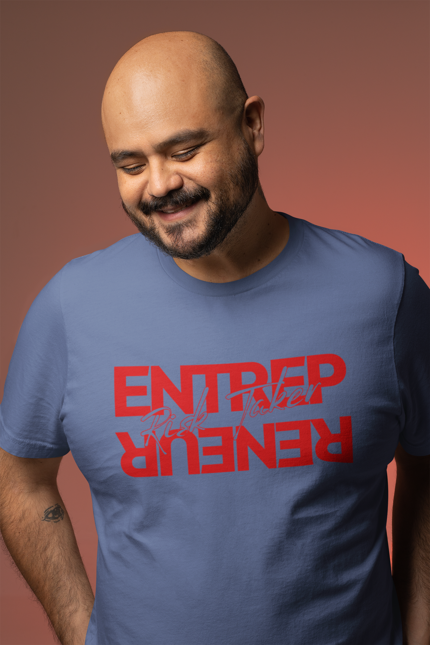 Man wearing a blue t-shirt with red text on a brown background