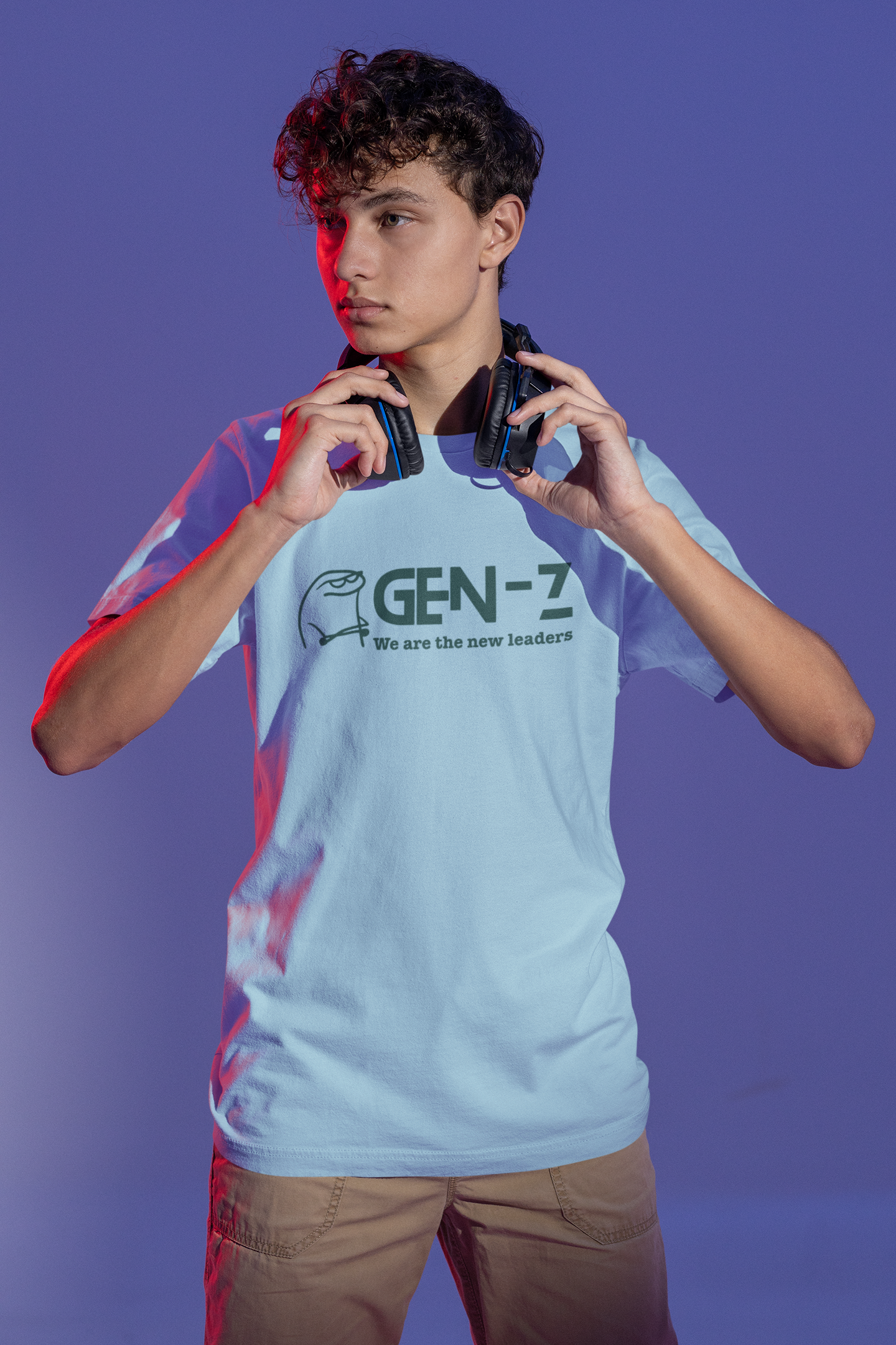 Person wearing a light blue t-shirt with 'GEN-Z' text, holding headphones against a purple background