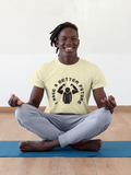 Person meditating on a yoga mat wearing a t-shirt with a graphic design.