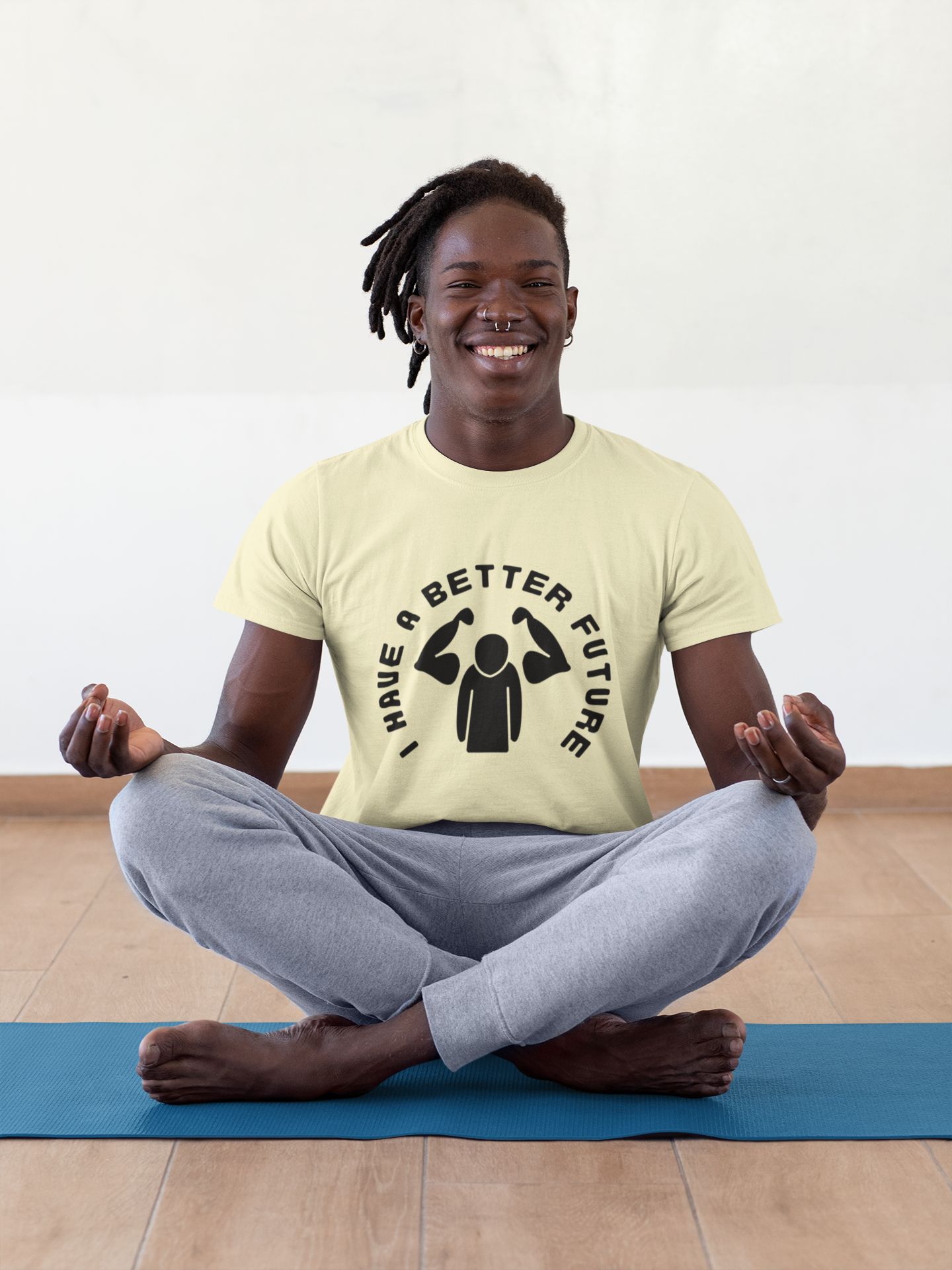 Person meditating on a yoga mat wearing a t-shirt with a graphic design.