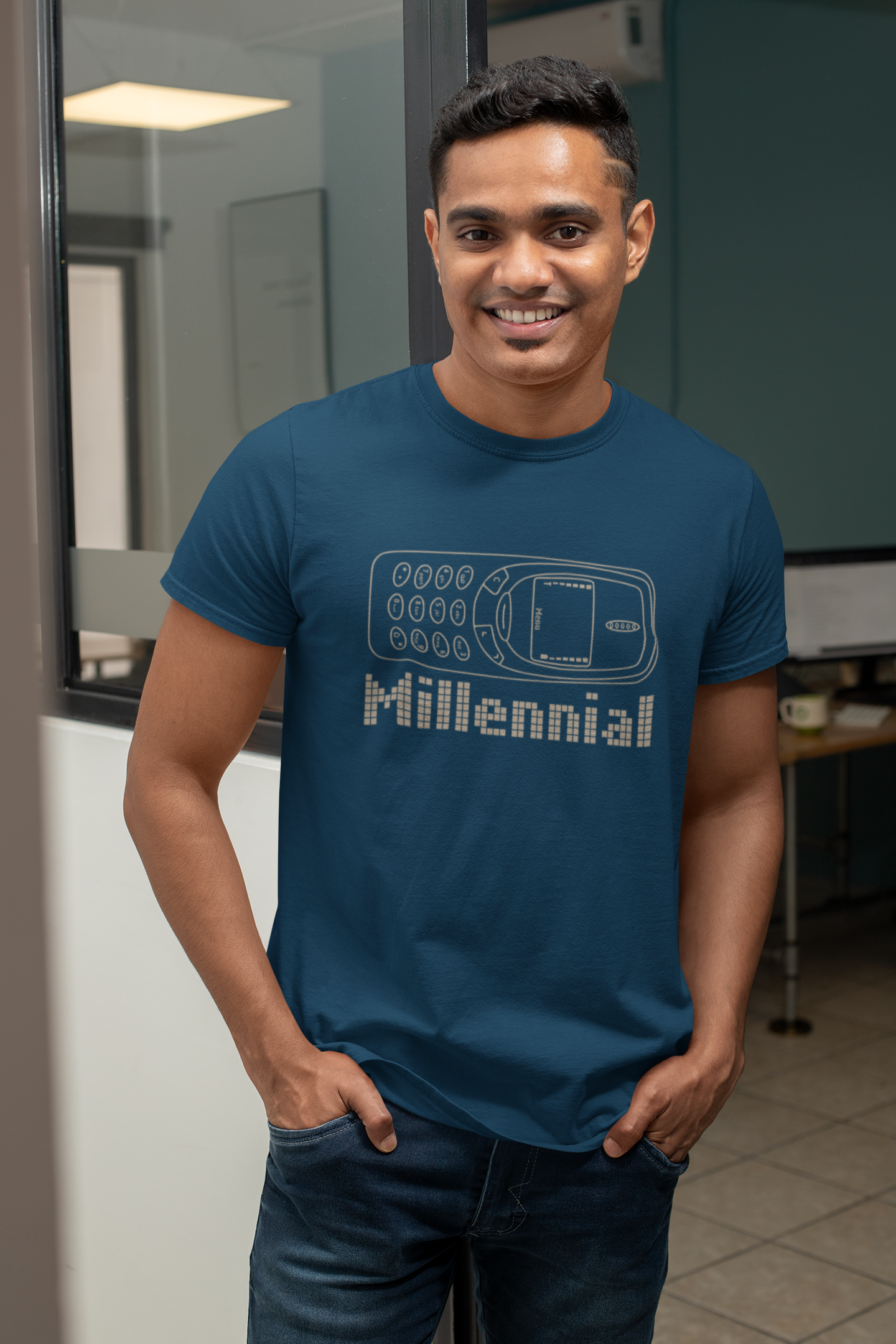 Man wearing a blue t-shirt with 'Millennial' design in an office setting