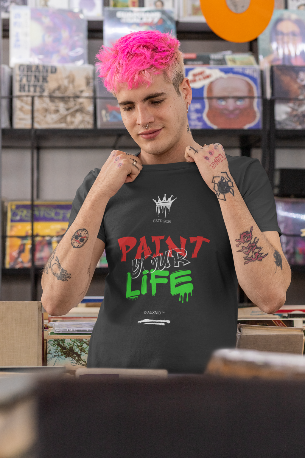 Person wearing a black t-shirt with colorful text in a store setting