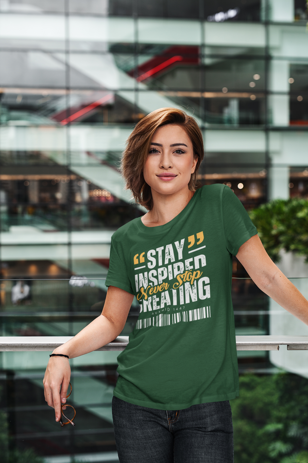Woman wearing a green t-shirt with motivational text in an indoor setting