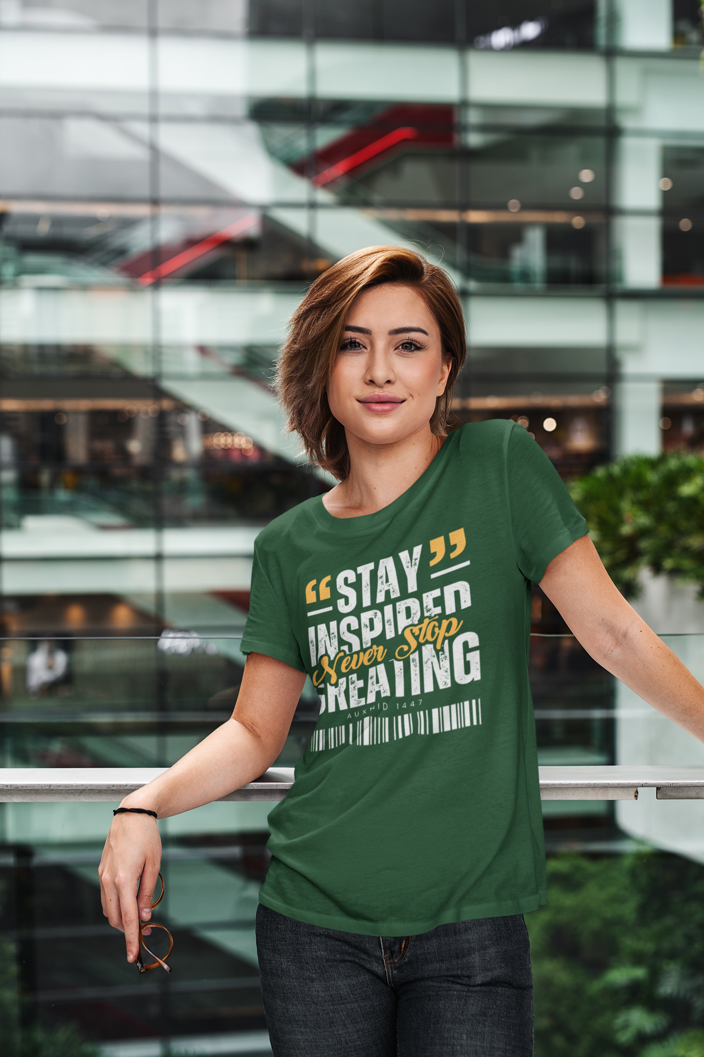 Woman wearing a green t-shirt with motivational text in an indoor setting